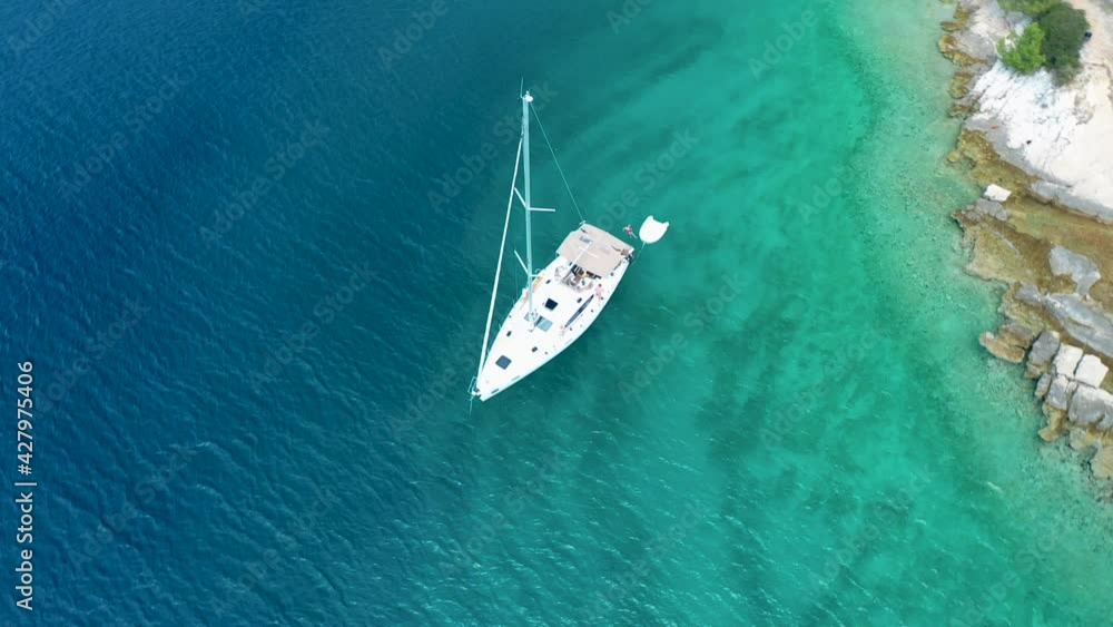 Sailboat Adrift On Clear Blue Bay Waters In Island Brac, Croatia. Osibova Bay In Milna. drone orbit Sailboat Adrift On Clear Blue Bay Waters In Island Brac, Croatia. Osibova Bay In Milna. drone orbit