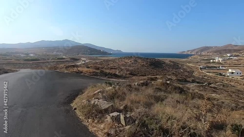 Awesome ocean view by the road driving a motorbike and a quad in mykonos greece photo