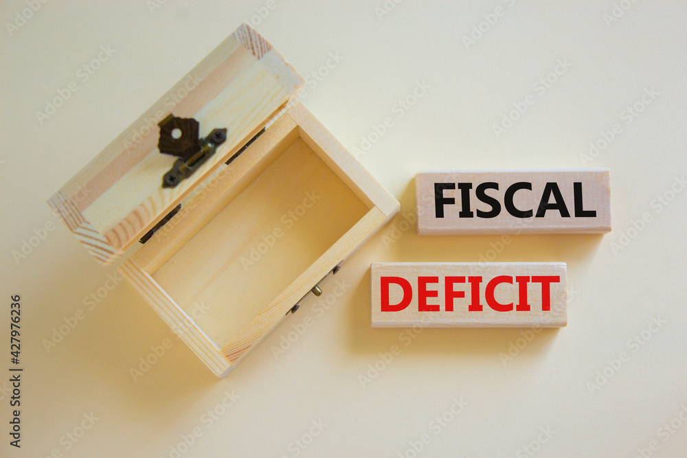 Fiscal deficit symbol. Concept words 'fiscal deficit' on blocks on a beautiful white background, small empthy chest. Business and fiscal deficit concept, copy space. Fiscal deficit symbol. Concept words 'fiscal deficit' on blocks on a beautiful white background, small empthy chest. Business and fiscal deficit concept, copy space.