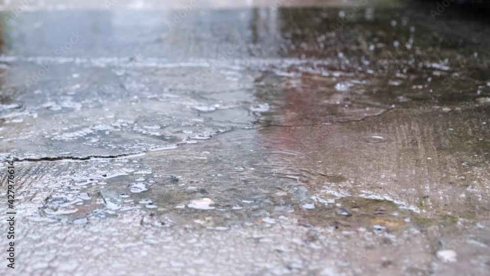 Rain Falling On Asphalt With Puddle. close up Rain Falling On Asphalt With Puddle. close up