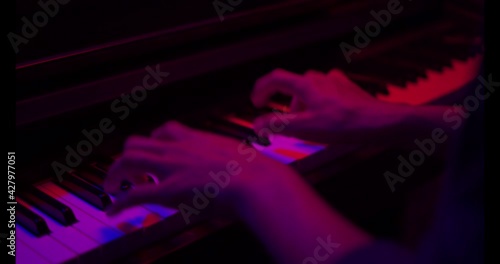 Close up of finger musician at the piano , The pianist playing  piano in the room ,classic piano,neon light,funny,hobby.