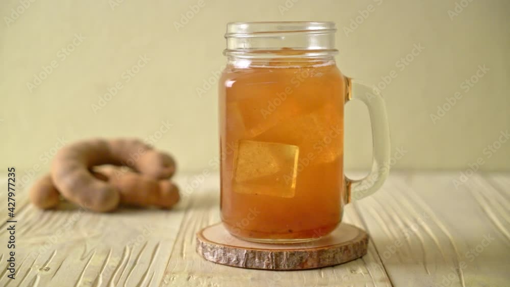 Delicious sweet drink tamarind juice and ice cube - healthy drink style Delicious sweet drink tamarind juice and ice cube - healthy drink style