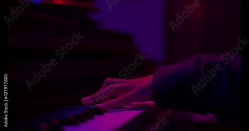 Close up of finger musician at the piano , The pianist playing  piano in the room ,classic piano,neon light,funny,hobby.
