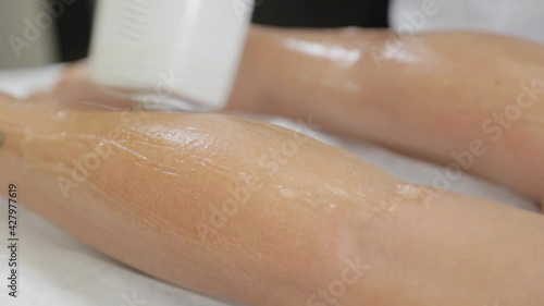 Wallpaper Mural Woman beautician makes laser hair removal on legs. Torontodigital.ca