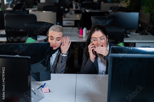 Bilde på lerret Curious young woman overhears a private telephone conversation of a colleague in