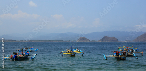Jember, Indonesia, Sept 12, 2015. Traditional fishing boats sailing over the coastal waters of Tanjung Papuma