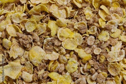 Dry breakfast cereal whole grains, granola and oat flakes concept background image.