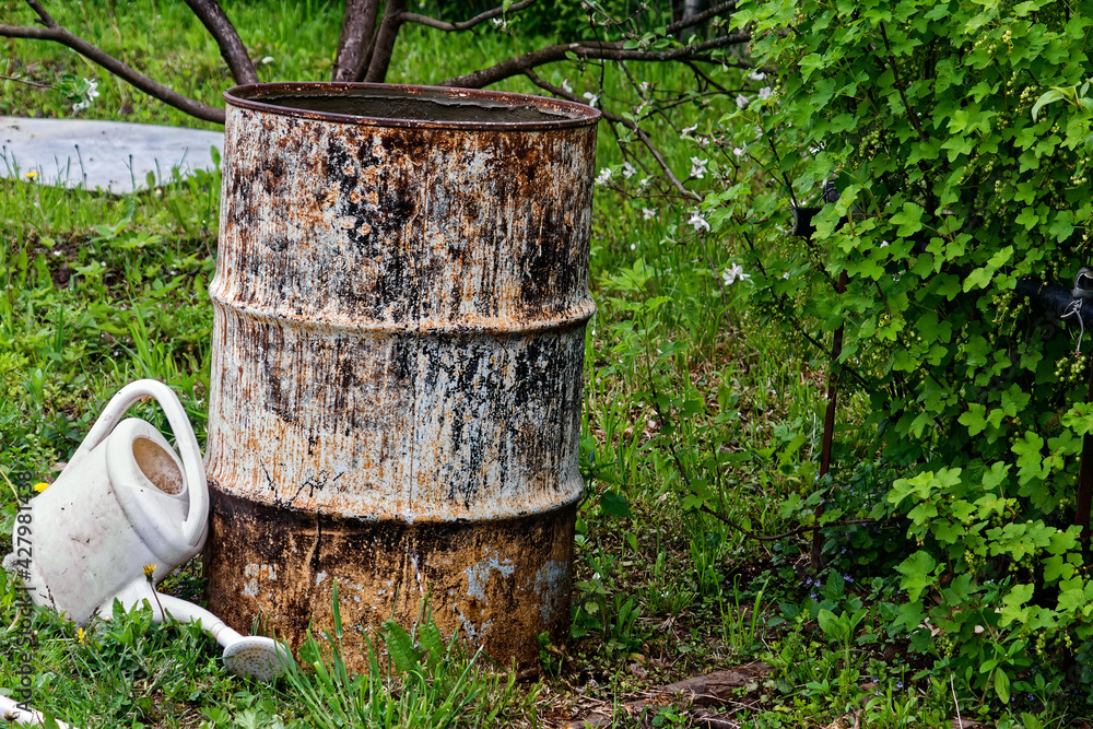 an old iron barrel stands among the trees an old iron barrel stands among the trees