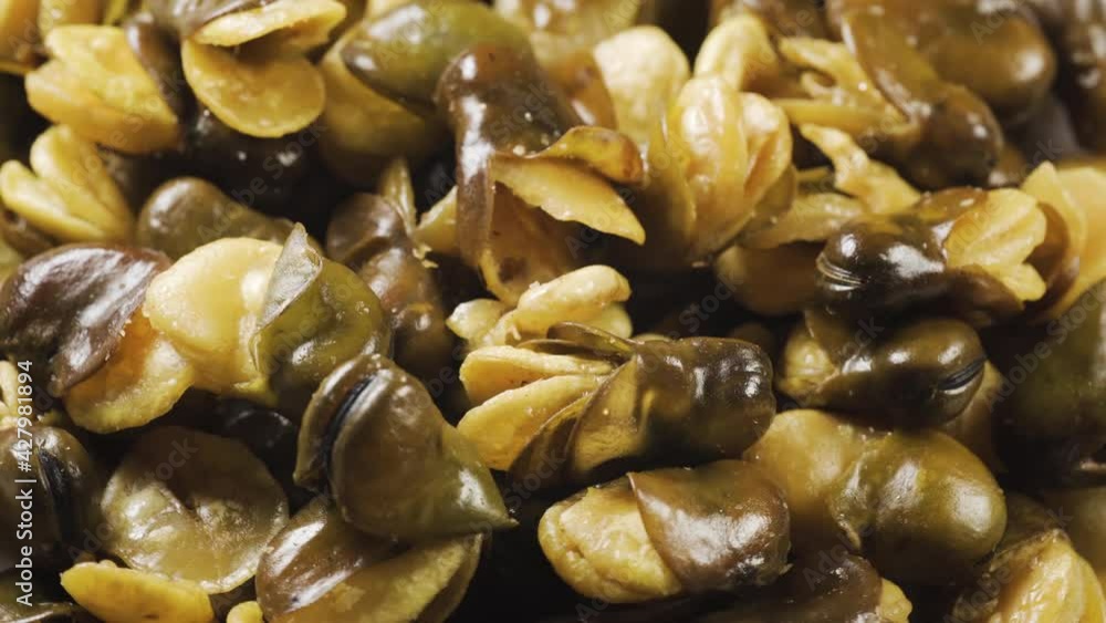 Fried broad bean on a rotating table. Snack food macro shot. Slowly spin around in pattern. Fried broad bean on a rotating table. Snack food macro shot. Slowly spin around in pattern.
