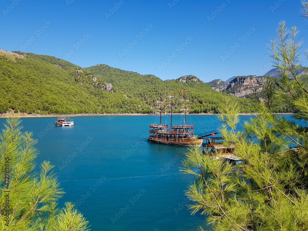 Seascape against the backdrop of mountains on a cloudless sunny day.