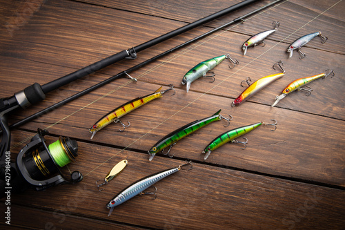 Canvastavla Fishing tackle - fishing spinning rod, hooks and lures on wooden background