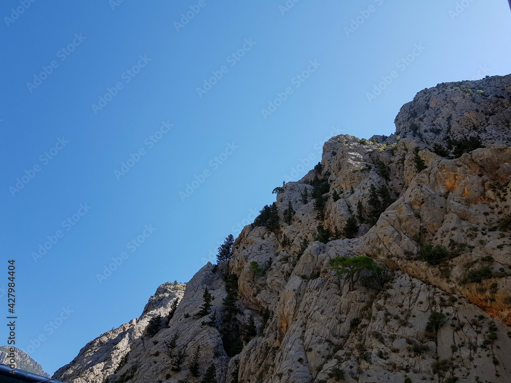 Seascape against the backdrop of mountains on a cloudless sunny day.