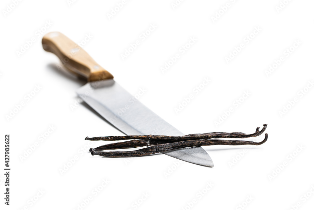 Obraz premium Vanilla pods on knife. Sticks of vanilla