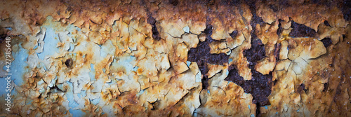 Texture of rusty metal with peeling paint. Rough metal surface with rust. Corroded and oxidized old iron. Rusted and aged metal sheet. Wide panoramic texture for background and design in grunge style.
