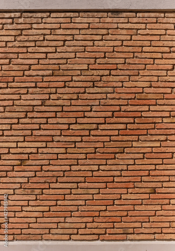Red brick pattern. Old brick wall with cracks and scratches. Horizontal brick wall background. Vintage house facade. Vertical composition.