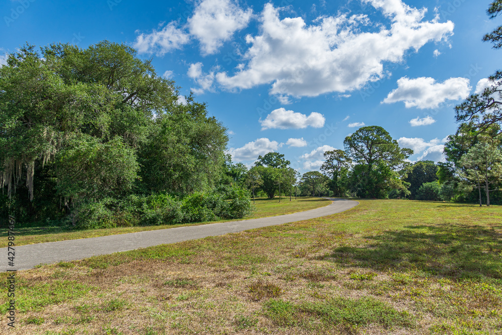 Curving paved pathway across Pine Island Ridge Natural Area - Davie, Florida, USA Curving paved pathway across Pine Island Ridge Natural Area - Davie, Florida, USA