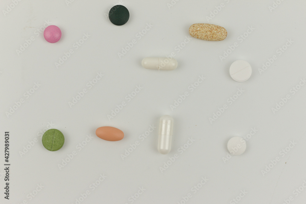 Pharmacy background on a white table. Tablets on a white background. Pills. Medicine and healthy. Close up of capsules. Different kind of pills