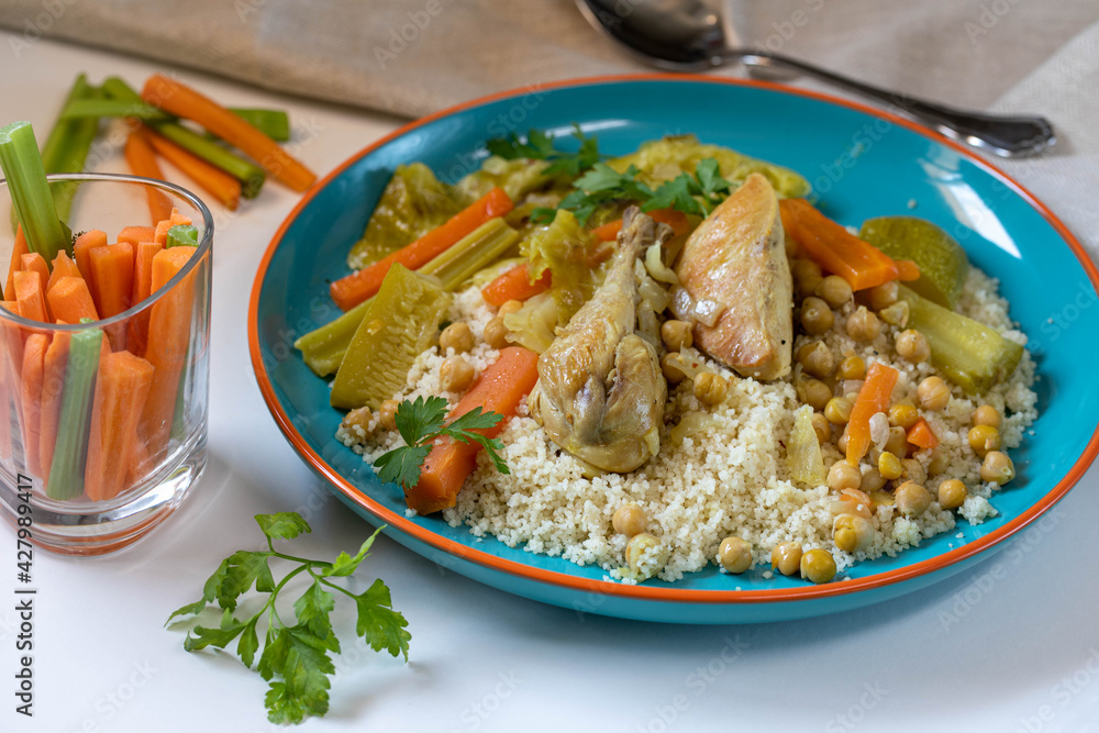 Chicken stew with vegetables, hummus and couscous.