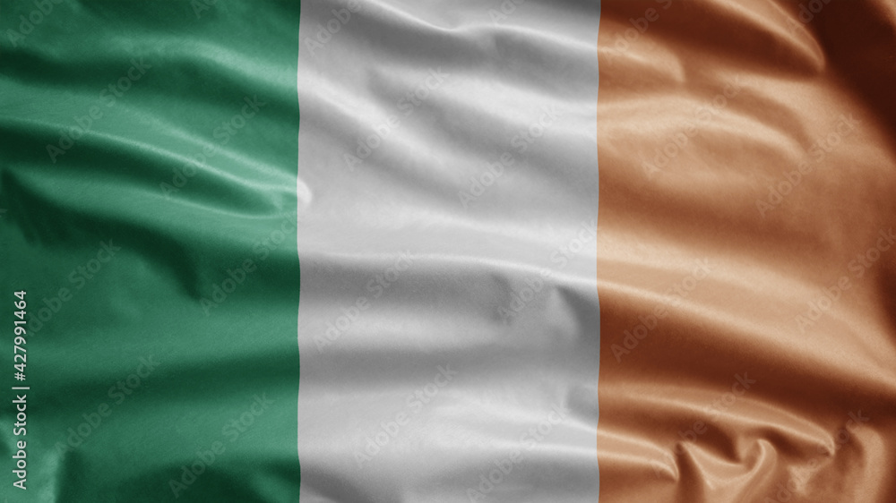 Ireland flag waving in the wind. Close up of Irish banner blowing soft silk.