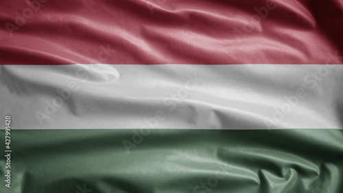 Hungarian flag waving in the wind. Close up of Hungary banner blowing soft silk.