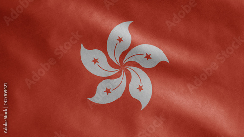 Hongkong flag waving in the wind. Close up of Hong Kong banner blowing soft silk photo