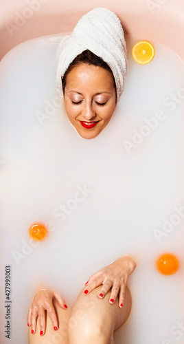 A woman taking a milk bath.