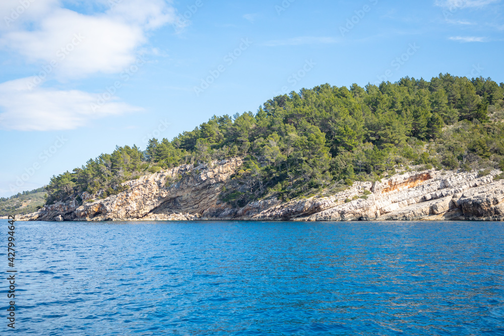 View from water of rocky shore of island in Croatia View from water of rocky shore of island in Croatia