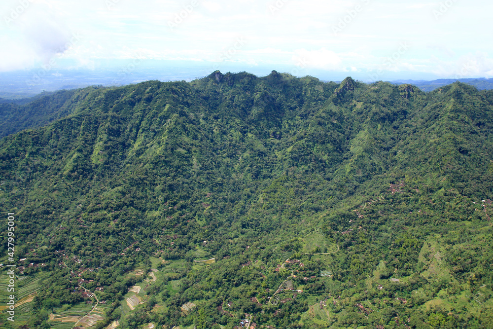 Aerial view of the green cliffs or hills of Menoreh extending from the west of Yogyakarta to Purworejo, Central Java. 