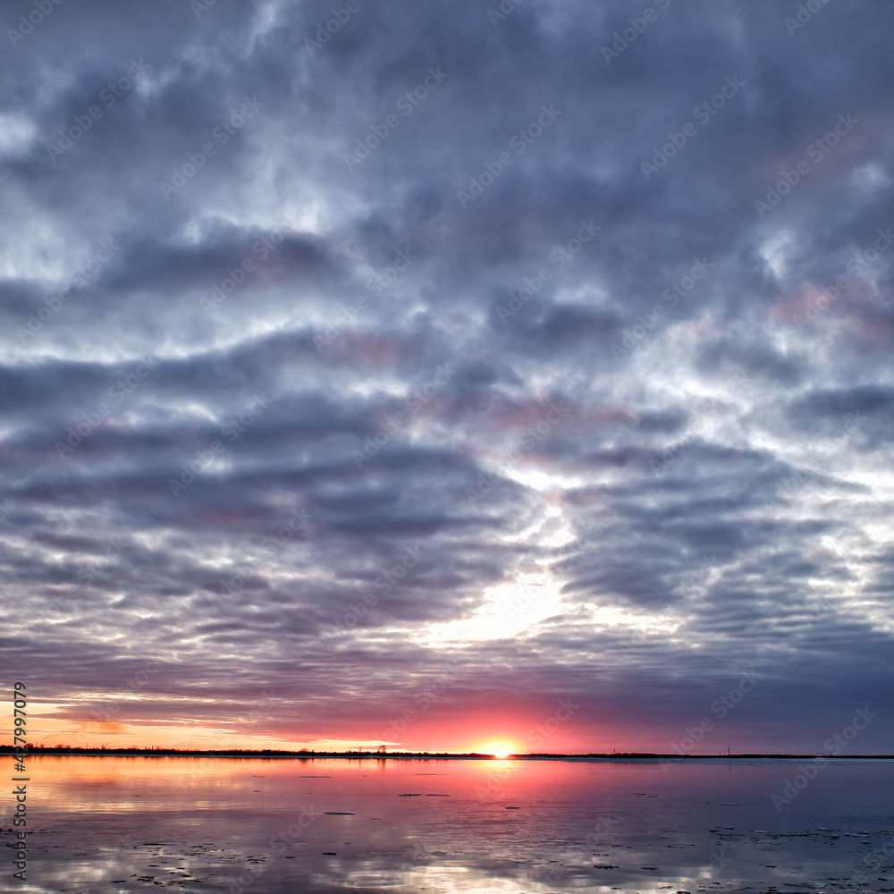 evening sunset over the river freed from ice, ice drift in spring. evening sunset over the river freed from ice, ice drift in spring.