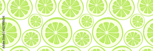 Bright summer tropical seamless pattern with green round pieces of lemon, lime. Cool print for clothes, wrapping paper, packing of goods, covers, napkins, tablecloths, wall-paper, posters, gift cards