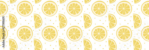 Bright fruity seamless pattern with yellow round and semicircular slices of lemon. Wide background for banner, poster. Cool print for children's and teenage clothes, wrapping paper, packaging, covers