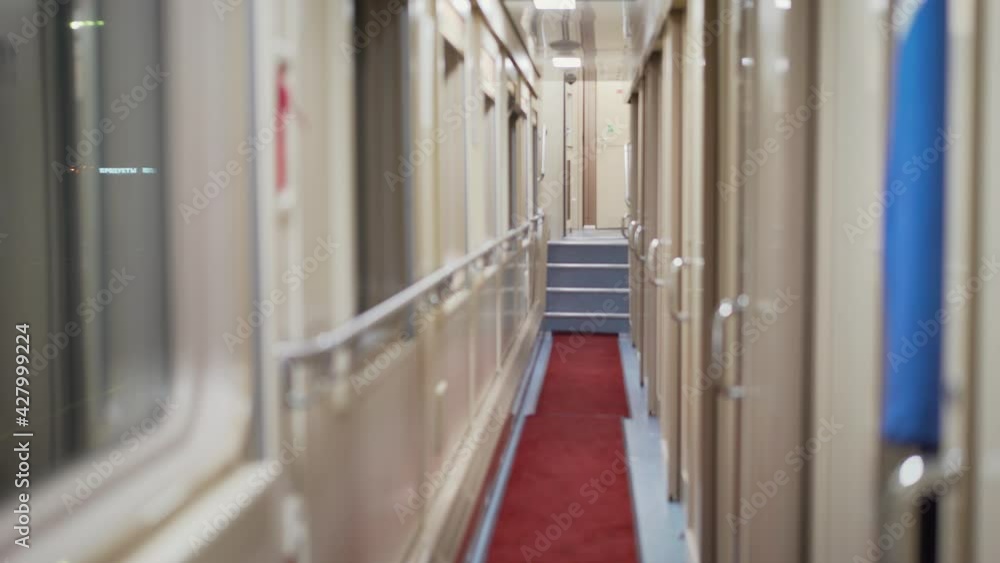 Corridor in the sleeping car of train. Rail travel. Corridor of the compartment car of the train. The compartment carriage of the train. Corridor in the sleeping car of train. Rail travel. Corridor of the compartment car of the train. The compartment carriage of the train.