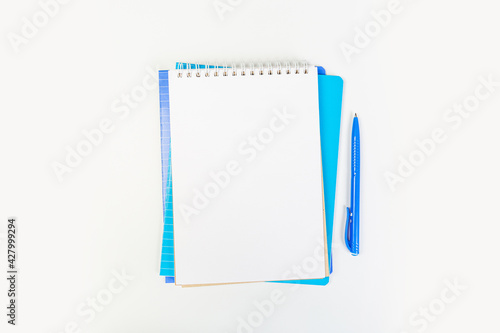 top view of an open notebook with a pen on a gray background, school notebooks with a spiral spring, office notepad. desktop concept, learning