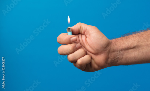 Obraz na plátně man hand with lighter with fire flame