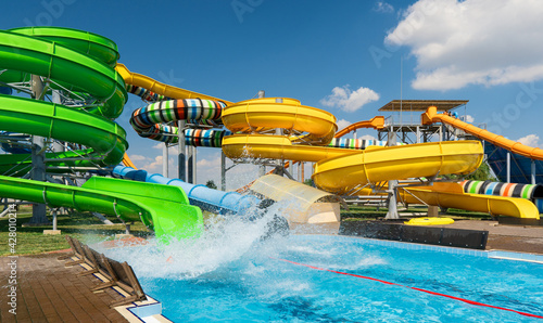 Valokuva water park, bright multi-colored slides with a pool, a water park on a summer da