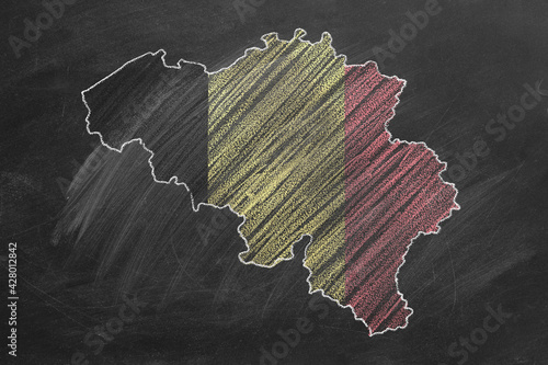 Country map and flag of Belgium drawing with chalk on a blackboard. One of a large series of maps and flags of different countries. Education, travel, study abroad concept. 