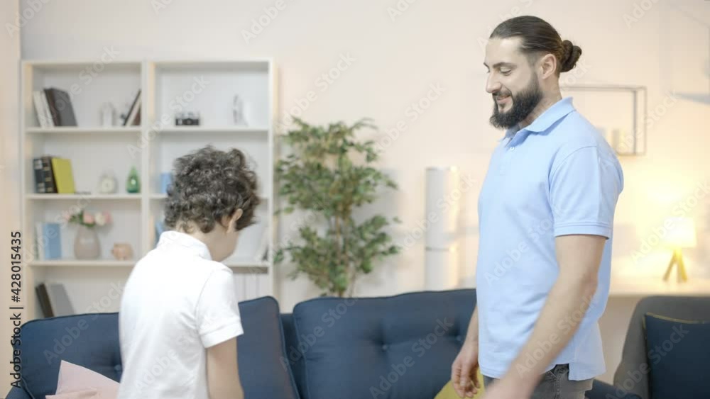 Father giving son pocket money, financial literacy for kid, responsibility