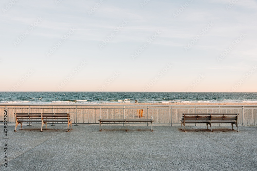 Benches on the Rockaways Boardwalk and view of the beach, in Queens, New York City
