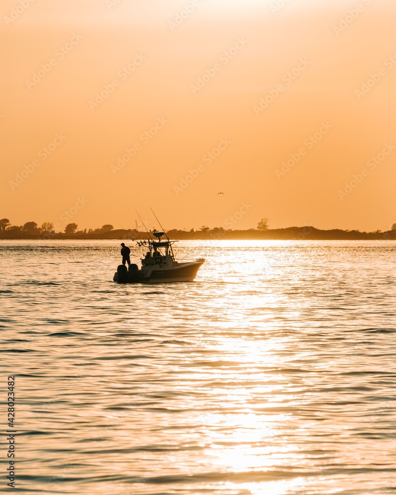 Boat at sunset in the Great South Bay, seen from Kismet, Fire Island, New York