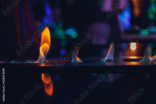 The flames in electric fireplace close-up. Interior.