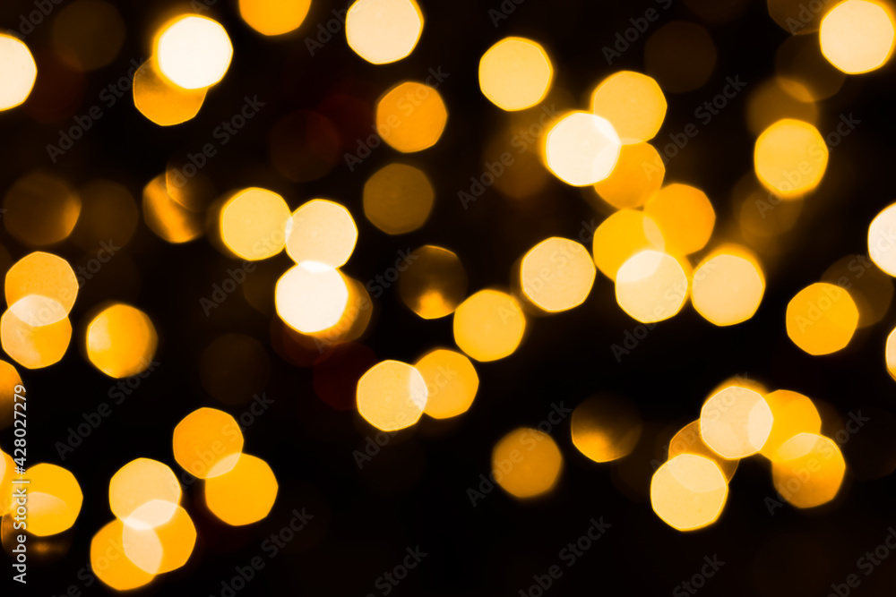 Gold defocused lights bokeh with dark background