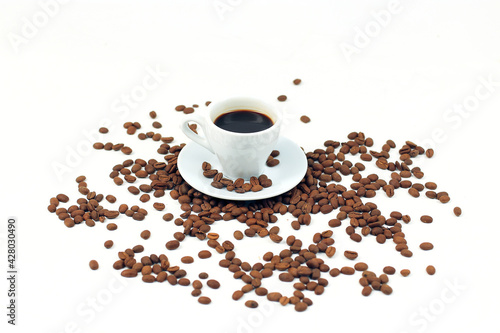 Ceramic coffee cup, many coffee beans isolated on white background