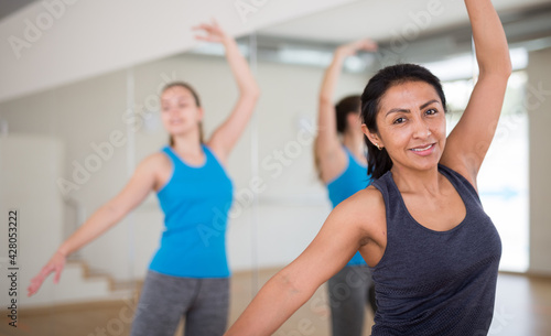 Young adult colombian woman dancing during group class in dance center © JackF