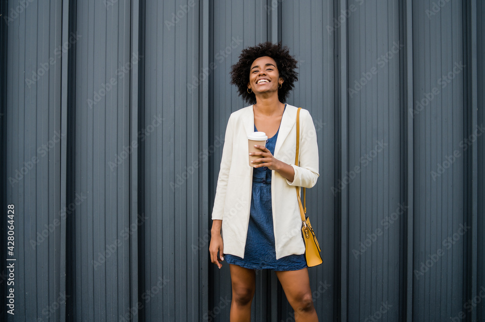 Portrait of afro business woman outdoors.