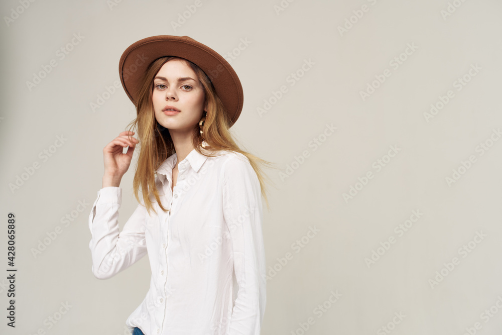 Pretty woman in hat white shirt elegant style fashion light background Pretty woman in hat white shirt elegant style fashion light background