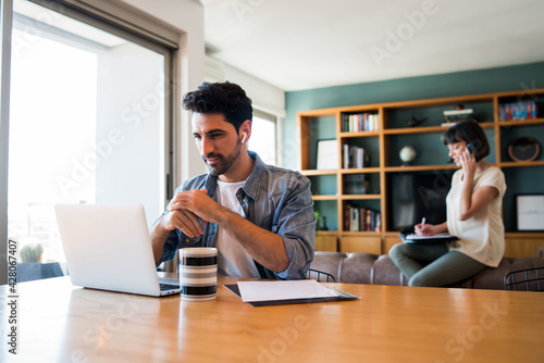 Business man working with laptop from home. photo