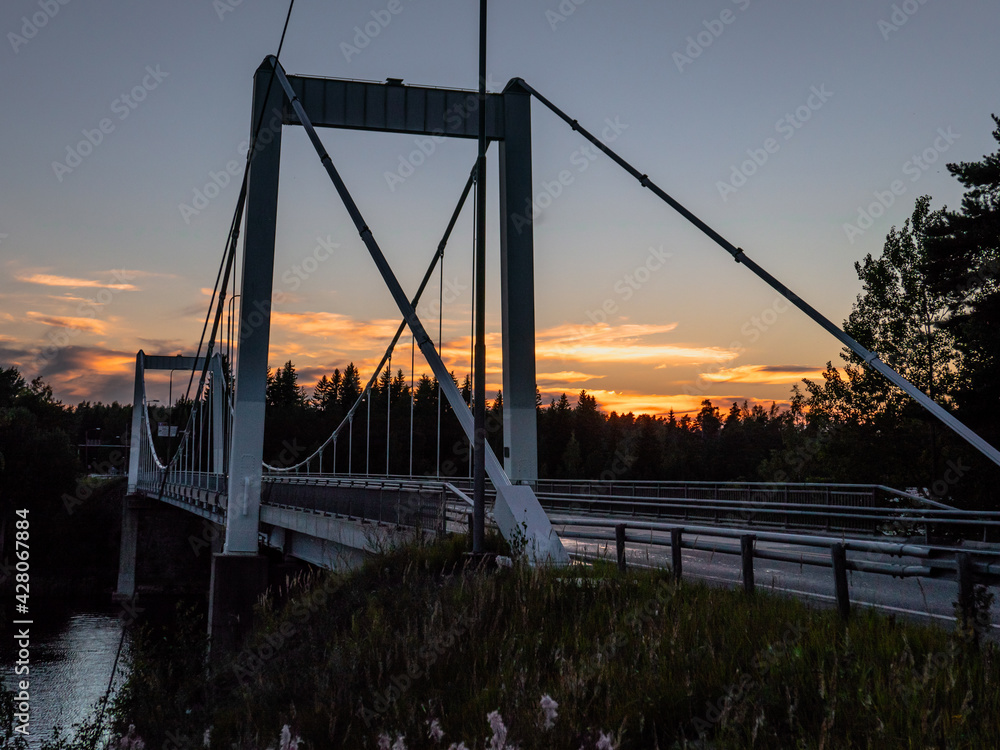 Obraz premium Bridge of Kirkonvarkaus in Mikkeli, Finland. Beautiful sunsetnon background.