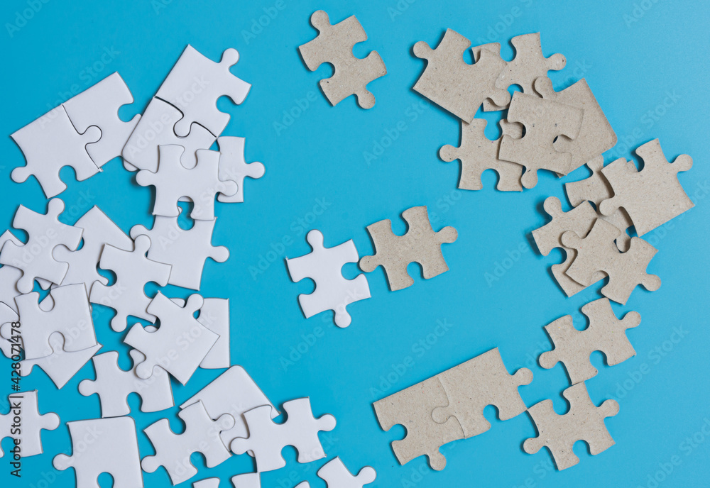 Jigsaw puzzle on blue background,contrast concept. Jigsaw puzzle on blue background,contrast concept.