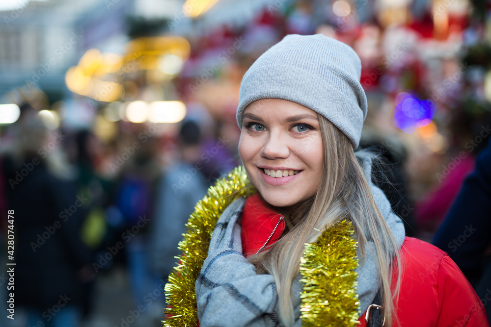 Portrait of young woman smiling happy on Christmas market