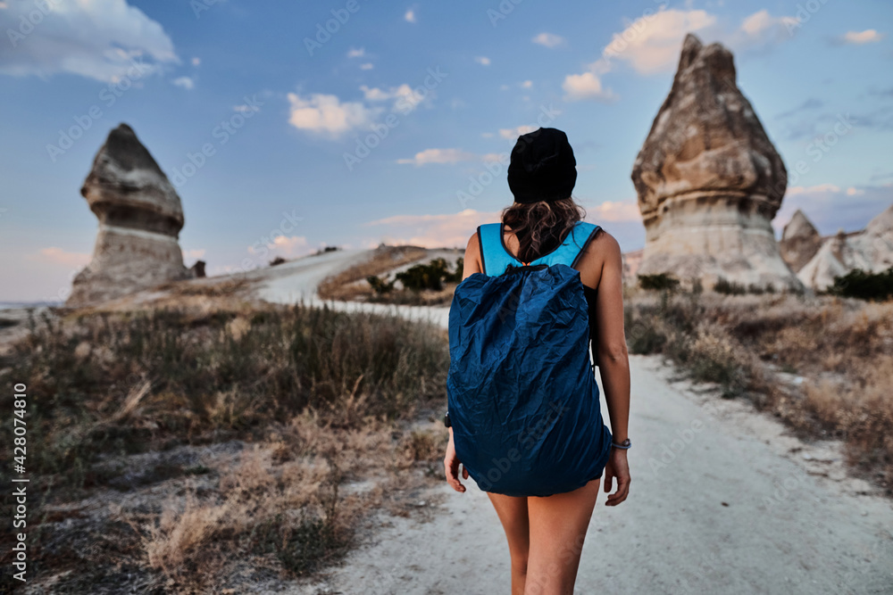 Beautiful tourist woman walking in Love valley in Goreme village
